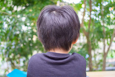 Japanese children playing in a garden with Griffith's ash treesの写真素材