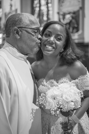 NEW YORK CITY, USA - July 10, 2018: priest kisses the bride at wedding in the churchのeditorial素材