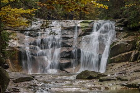 Autumn waterfall Mumlava at Krkonose mountains, Harrachov, Czech Republic with long exposureの写真素材