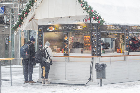 PRAGUE, Czech Republic - DECEMBER 12th 2022: Chicken and drinks stall on Wenceslas Square in Christmas time, snow winter weatherのeditorial素材
