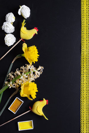 Easter decoration and flowers flat lay, yellow on black, holiday spring decor, chickensの写真素材