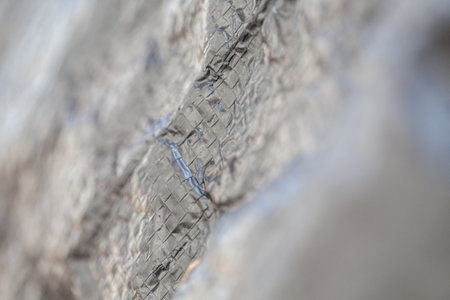 Textile old protection bag, black defocused texture, closeup
