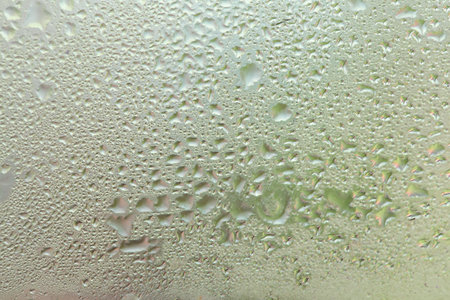 Water drops on a window, textured background, pastel colors, defocused shotの写真素材