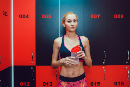 Before training. Girl in a gym locker roomの写真素材
