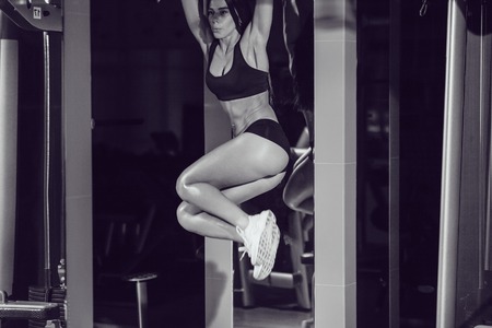 Sexy girl doing abdominal exercises in the gym