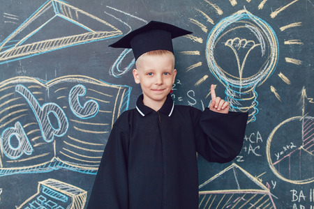 Child scientist posing in front of blackboardの写真素材