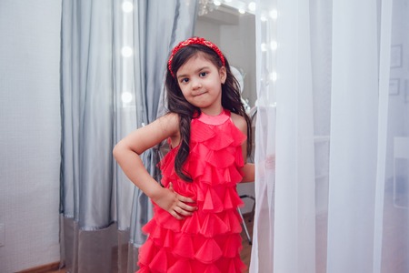 Little girl in hair curlers in a beauty studioの写真素材