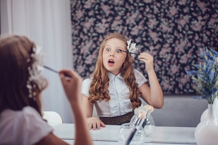 Little girl in hair curlers in a beauty studioの写真素材