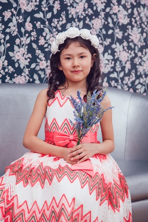 Little girl in hair curlers in a beauty studioの写真素材