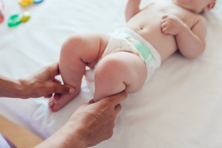 Woman doing exercises and massage the babyの写真素材