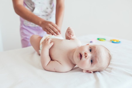 Woman doing exercises and massage the babyの写真素材