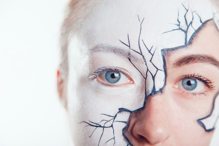Girl with Halloween face art on white backgroundの写真素材