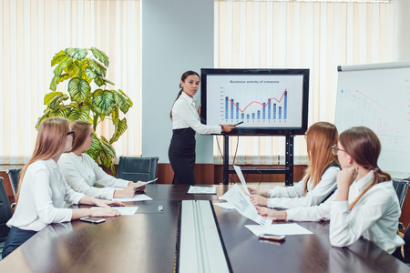 Manager presenting business activity plan to his colleaguesの写真素材
