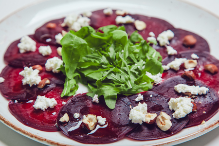 Fresh green salad with beets, goat cheese and olive oil, healthy food, organic.の写真素材