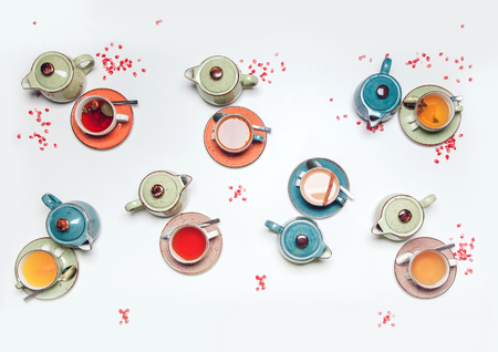 A cup and and tea pots with fruit tea on white table.の写真素材