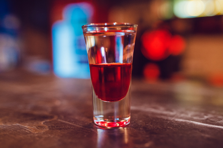 A cocktail made by layers. Shot at the bar.の写真素材