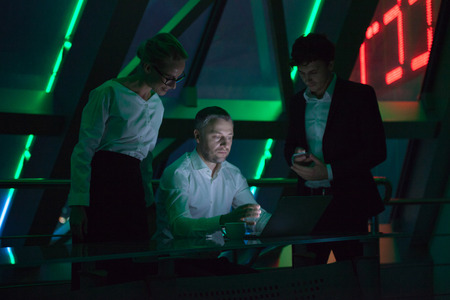 Group of business people working in a night office.の写真素材