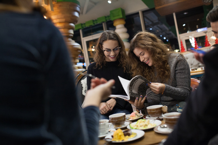 Group of teenagers doing homework in cafe.の写真素材