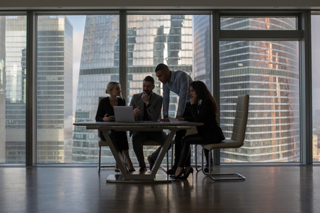 Business people working in an office on a background of panoramic windows.の写真素材