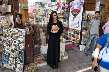 Dubai/UAE - March 13, 2018: A woman in abaya walks the market in Deira.