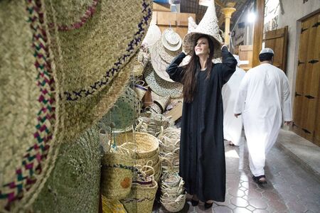 Dubai/UAE - March 13, 2018: A woman in abaya walks the market in Deira.