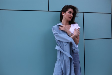 Attractive young woman on a turquoise background.の写真素材