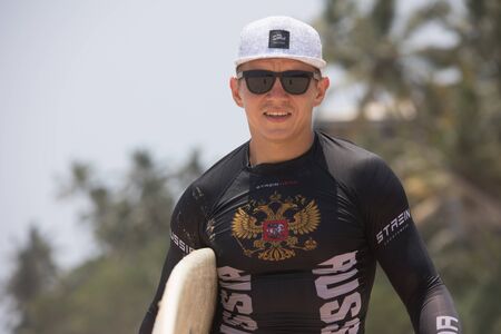 Mirissa/Sri Lanka - April 4, 2018: A man with a surfboard.のeditorial素材
