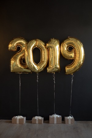 Sign 2019 made of golden balloons for new year on black background.の写真素材