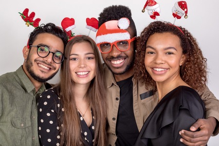 Four friends in funny New Year accessories.の写真素材