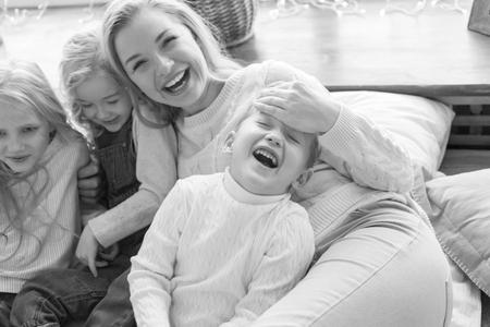 Mother with three children have fun.の写真素材