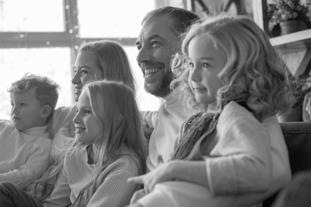Happy and friendly family hugging on the couch.