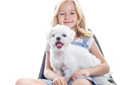 Cute little girl with funny puppy on white background.の写真素材