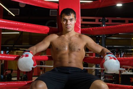 CHELYABINSK, RUSSIA â June 8, 2019: Male boxer sits in the corner of the ring.のeditorial素材