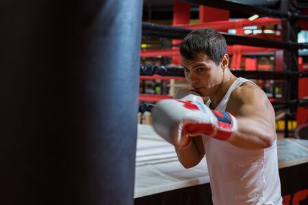 CHELYABINSK, RUSSIA â June 8, 2019: A man is practicing punches on a punching bag. Girl boxingのeditorial素材