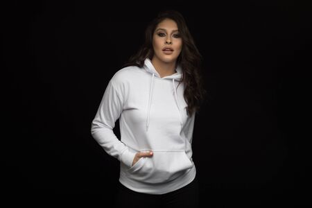 Attractive young woman in a white hoodie. Mock-up.の写真素材