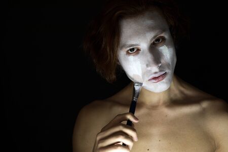 Man gets white paint on the face.