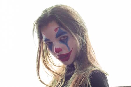 Portrait of a girl with clown makeup isolated on white background.