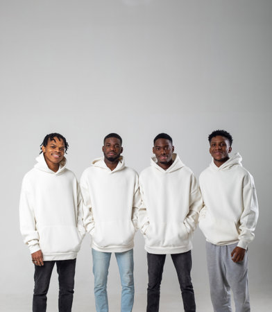 Group of African American guys in brown hoodies posing on a white background wearing sunglasses