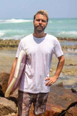 A Surfer at Rocky Beach, fully prepared and eager for an exciting adventure awaits