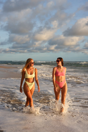 Experience a trendy beach walk filled with stylish summer vibes and breathtaking sunsetsの写真素材