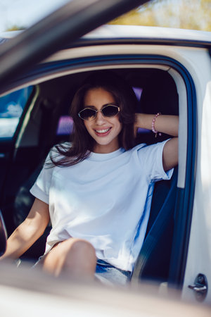 Stylish Woman Sitting in Car Wearing Sunglassesの写真素材