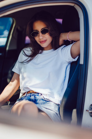 Stylish Woman Sitting in Car Wearing Sunglassesの写真素材
