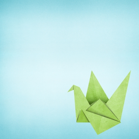 Origami bird recycled paper backgroundの写真素材