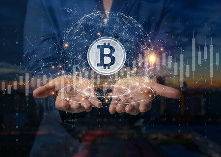 Businessman is holding a bitcoin as part of a business network, Cryptocurrency blockchain connection, Technology and financial investment background concept.の写真素材