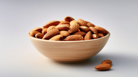 almonds in a bowl on a white backgroundの素材