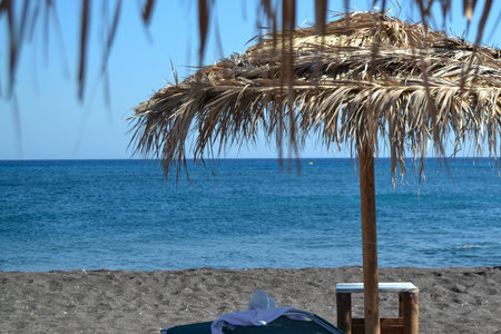 Umbrella and chair on the beach in Crete, Greeceの写真素材