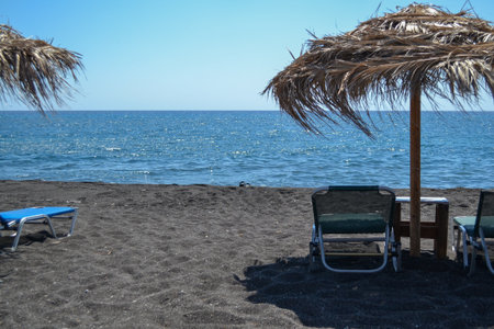 Beach umbrellas and chairs on the black sand of the Black Seaの写真素材