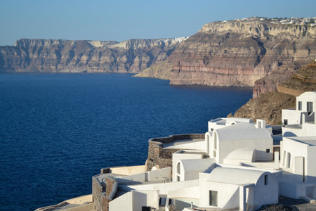 Image of white architecture on a slope of a hill at sunset, Oia, Santorini, Greeceの写真素材