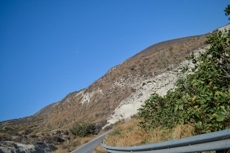 Road to the top of the mountain with blue sky in the backgroundの写真素材