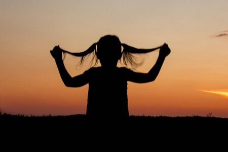 girl on the background of sunsetの写真素材